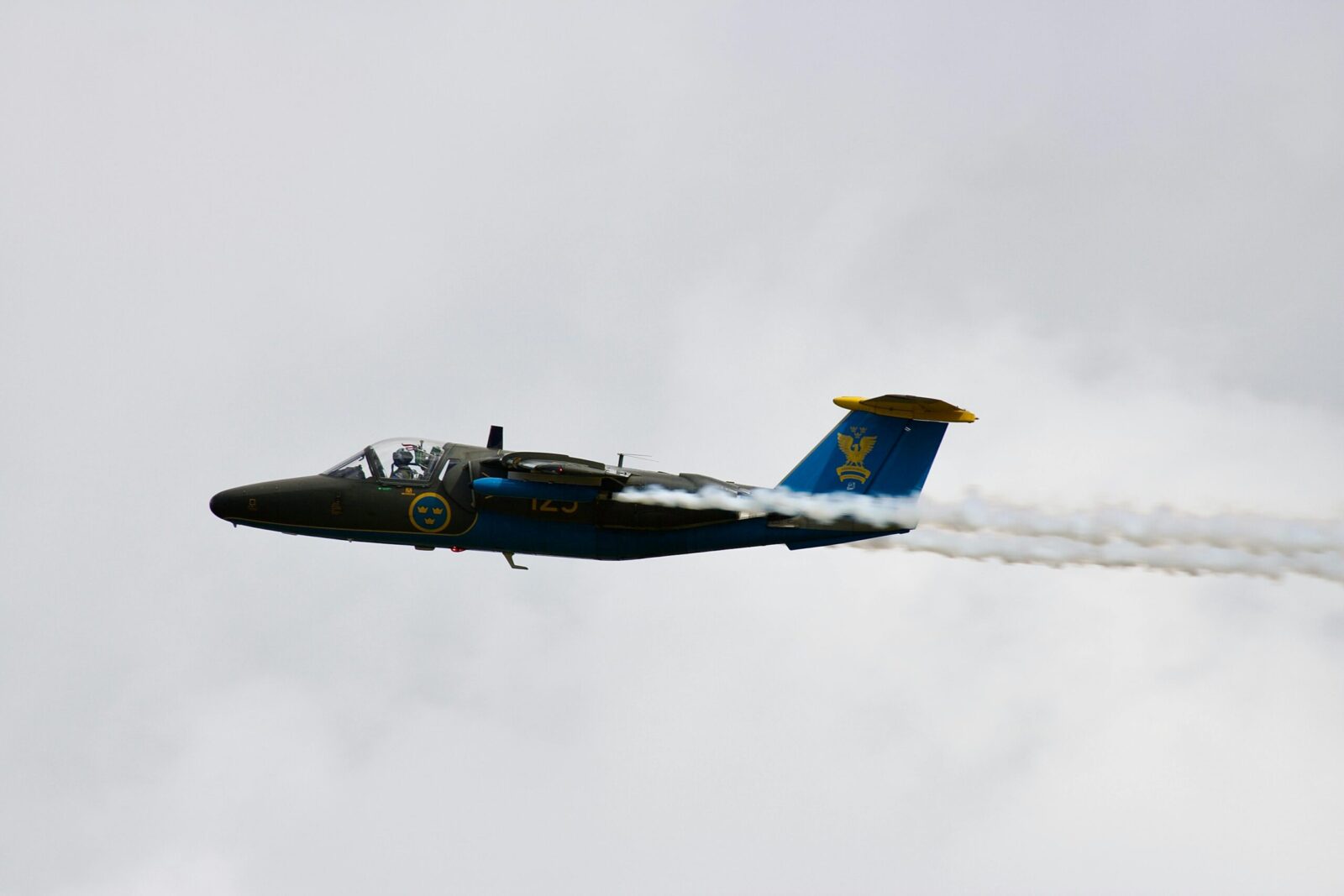 Swedish Air Force jet flying with smoke trails during an aerial display in England.
